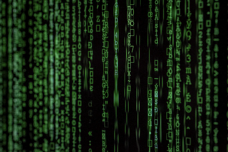 Streams of code on a dark monitor representing log analysis